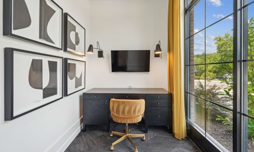 small room with chair, table and tv