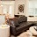 Living room with chairs, table, dining area and TV in The Hartley at Blue Hill apartment complex in Chapel Hill, NC