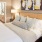 Bedroom with large bed, ensuite. queen bed and nightstands.