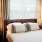 Bedroom with large bed, ensuite. queen bed and nightstands.